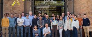 A group picture of all researchers standing in front the door of an old building.