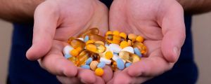 A pile of multi-colored pills in someone's hands. Volodymyr Hryshchenko
